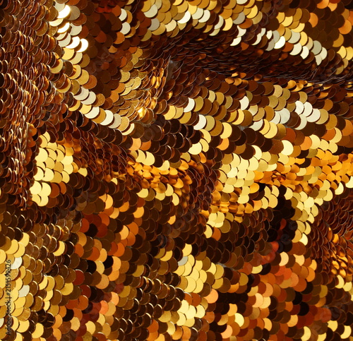 Gold sequin texture background with reflective sparkling . Abstract christmas backdrop, wallpaper.