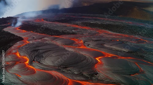 red glowing lava flow in volcanic landscape at night