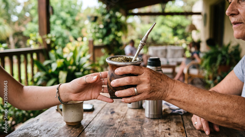 Sharing traditional South American yerba mate tea in a gourd on a rustic patio