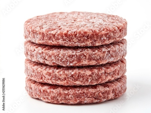 A Vertical Stack Of Four Raw Frozen Beef Burger Patties On White