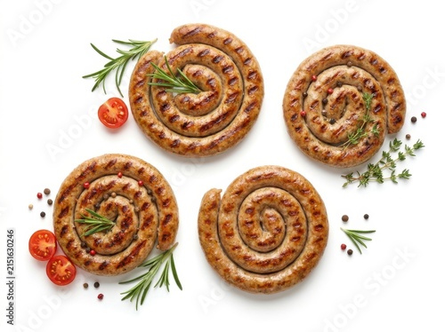 Four Delicious Spiral Grilled Sausages Garnished With Fresh Herbs And Cherry Tomatoes