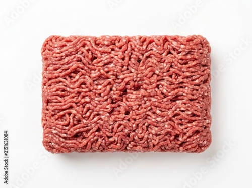 A block of fresh raw ground beef isolated on white background view