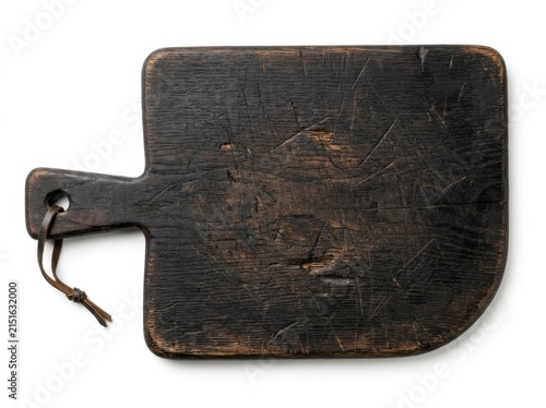 A Weathered Dark Wooden Cutting Board With A Leather Hanging Loop Attached
