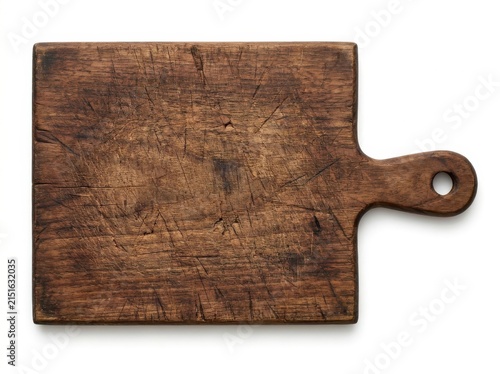 A Heavily Used Vintage Dark Wood Cutting Board With A Handle Isolated