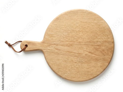 A circular light oak wooden cutting board with a leather hanging strap
