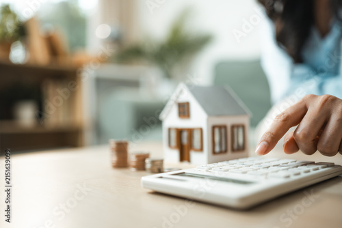 Canvas Print House model, calculator and coins illustrate solar energy investment, ROI calculation, energy savings and sustainable financial planning for efficient homes