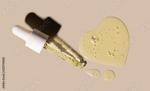 pipette drop of serum test on a beige background