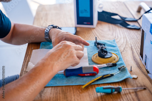Fotografía Close up of repairing yacht equipment with hand tools during a sailing trip on the Adriatic Sea