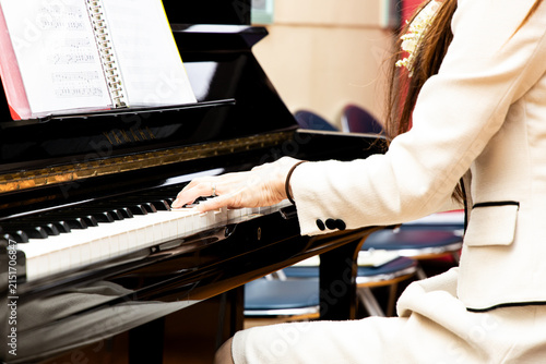 Fotografie Pianist performs in a music hall during a public recital event in the afternoon