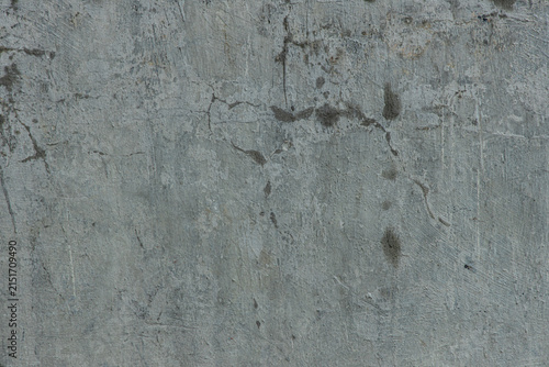 Concrete wall with cracks and stains showing signs of wear and aging