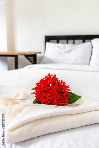Towel Decoration With Tropical Flower On Hotel Bed In Thai Hotel Room.