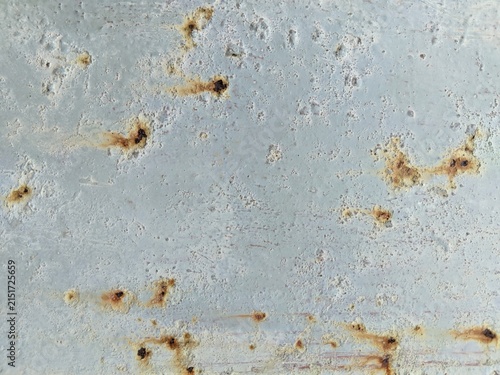 Canvas Print Close-up of rusty metallic surface with light gray painted background, abstract