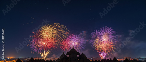Colorful fireworks over Indian temple silhouette at night for Diwali celebration, festival greeting, cultural events and festive seasonal background