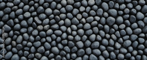 Natural black pebbles stones background texture with background material landscape wallpaper abstract close-up