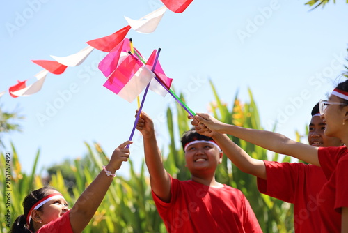 Photography Children's hands wave Indonesia's Red and White flag in celebration of the national Independence Day