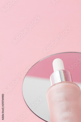 Close up of pink dropper on the mirror, luxury skincare product visuals for advertising