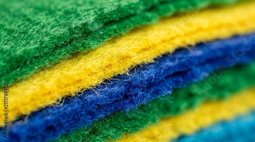 Macro Stacked Felt and Fleece Layers in Green Yellow and Blue for Industrial Textile and Craft Supply Background