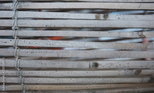 The surface of light gray split bamboo strips or stalks arranged closely together