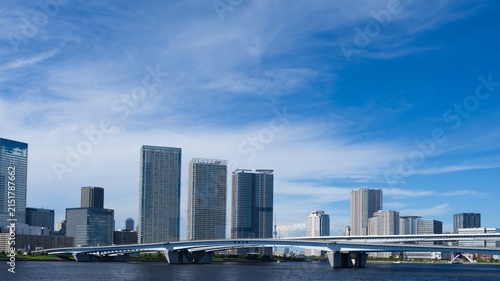 Canvas Print Modern City Buildings and Bridge Under Vasto Blue Sky with Clouds