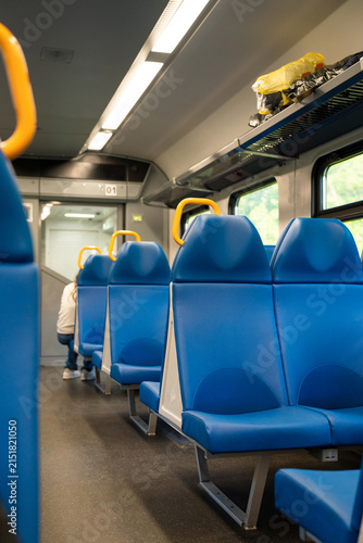 Cuadro en lienzo Empty Interior Commuter Train With Blue Seats While Driving