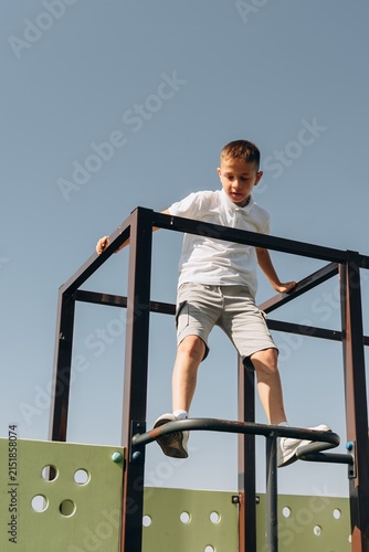Happy Boy Playing on Modern Playground