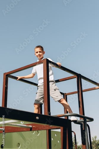 Happy Boy Playing on Modern Playground