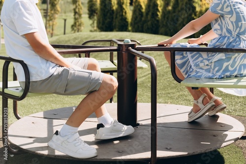 Happy Children Riding Playground Roundabout Together