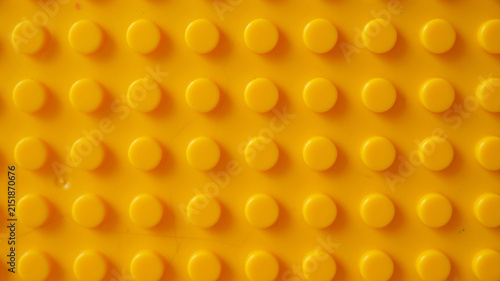 Seamless pattern yellow plastic building blocks brick toy.