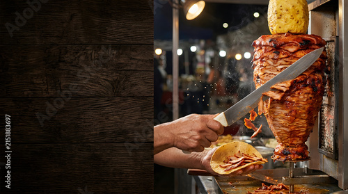 Chef Slicing Pork Off Trompo Spidery Spit For Tacos Al Pastor