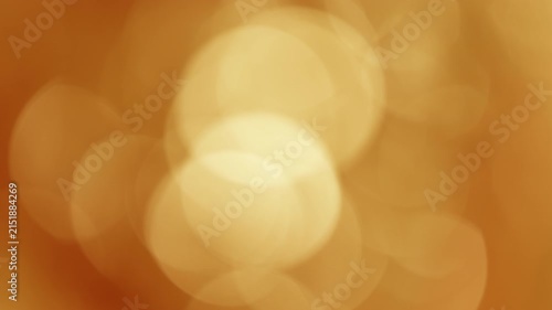 Large golden-amber bokeh circles shimmering and flickering in evening wind, relaxing nature background