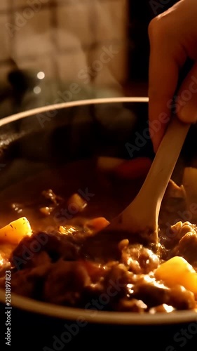 Hearty beef and potato stew cooking in pot.