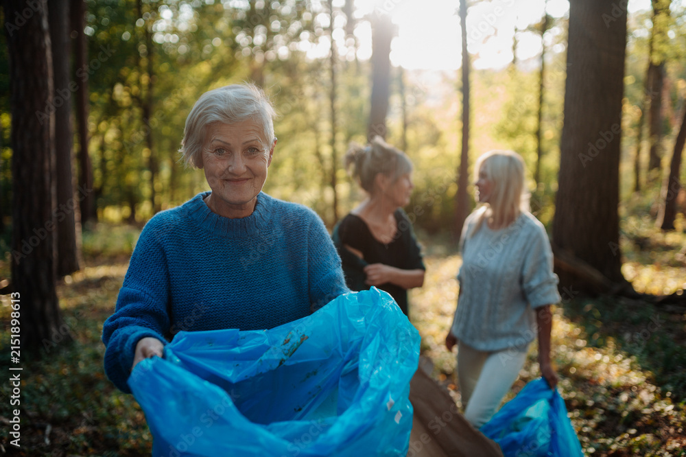 Fototapeta premium Senior women volunteering for nature protection and litter collection.