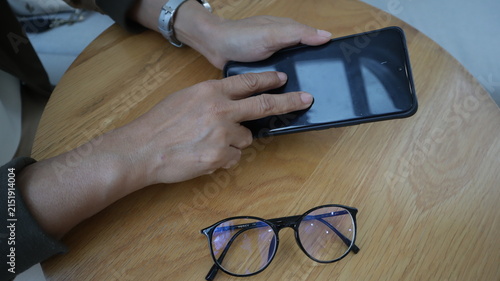 Professional business and financial planning concept featuring an entrepreneur working with a laptop, calculator, smartphone, and digital tablet at a wooden desk