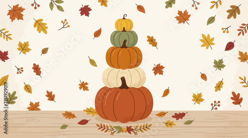 Stacked colorful pumpkins and falling autumn leaves on wooden tabletop
