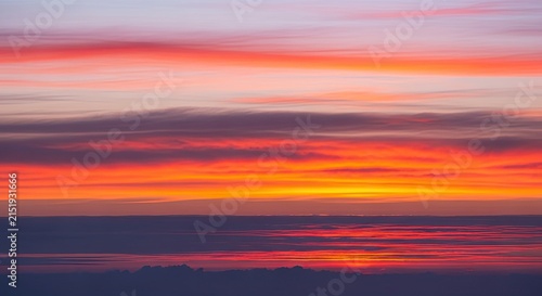 Vibrant and Colorful Sunset Sky with Reflective Water Surface.