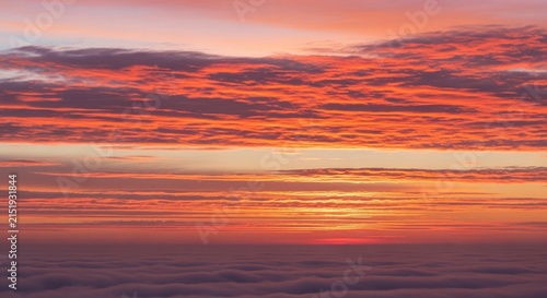Vibrant Sunset Sky with Fiery Orange and Purple Clouds.