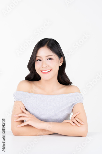 Portrait of beautiful young Asian woman with healthy facial skin and glowing makeup for beauty and cosmetics concept.