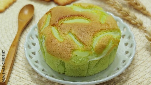 Pandan chiffon cake with young coconut on a white plate