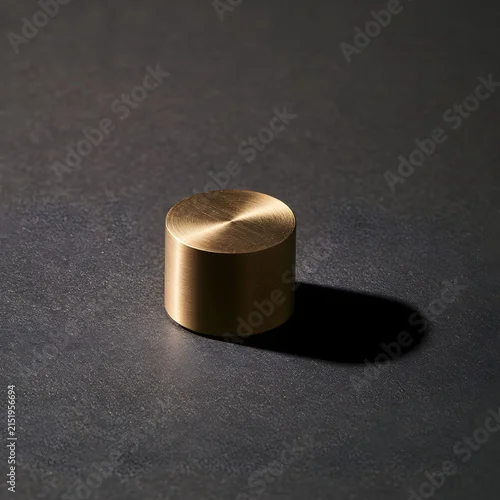Fototapeta samoprzylepna Minimalist Brass Weight on Charcoal Background