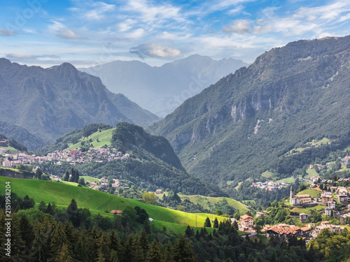 Alpine valley panorama with mountain villages and green meadows in summer, Oltre il Colle, Bergamo, Lombardy, Italy