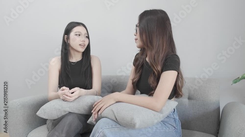Asian Woman Comforting a Sad Friend on the Sofa