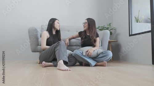 Asian Women Sitting on the Floor Having a Casual Conversation