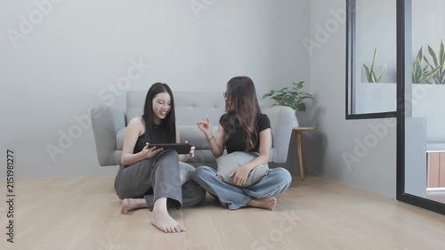 Asian Women Having a Fun Conversation While Using a Tablet for Online Shopping