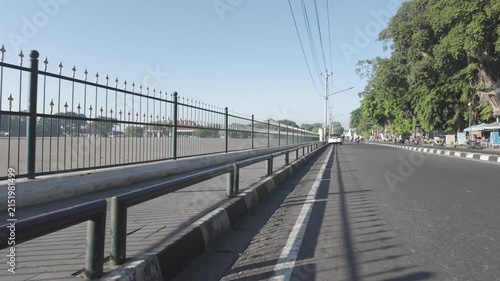  Yogyakarta, Indonesia, filmed on August 5, 2026, featuring the city road, pedestrian walkway, traditional surroundings, greenery, and passing traffic.
