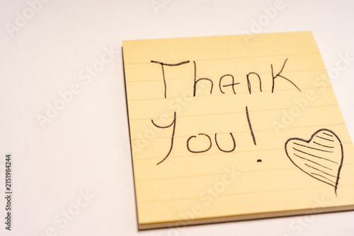 A handwritten note with the text Thank You  on it.