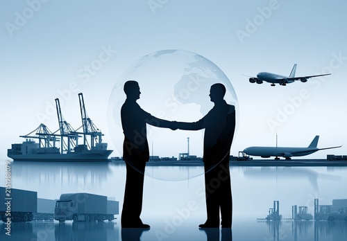 Silhouettes of men shaking hands against a global backdrop with shipping