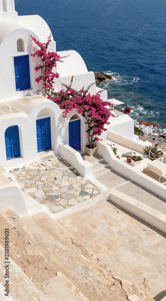Fototapeta premium White island buildings with bougainvillea cascading to sea
