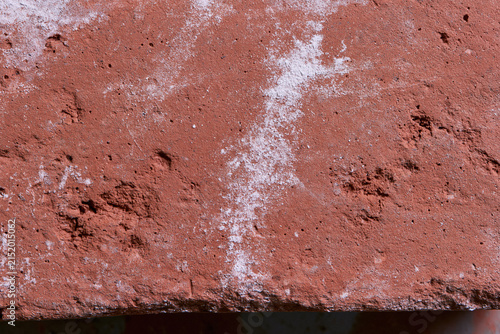 Macro detail of red clay brick texture with white efflorescence
