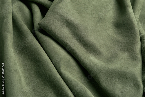 Sage olive green suede leather fabric macro background with smooth texture