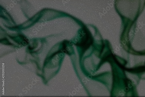 Dark abstract textured background with flowing green smoke trails and fine grain overlay for desktop wallpaper